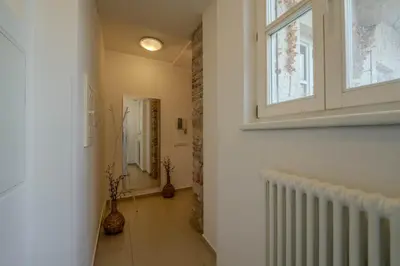 a hallway with a window and a tile floor at Centre Prague Retreat Residence in Prague
