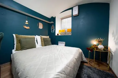 a bedroom with blue walls and a large bed at Secret Economy Studio Oasis in Prague