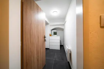 a hallway with a door and a room with a counter at Secret Economy Studio Oasis in Prague