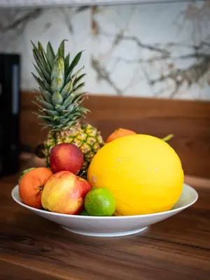 a bowl of fruit on a wooden table at Grand Deluxe Suite in Prague