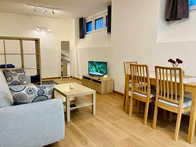 a living room with a couch and a table at Pleasant Basement Apartment in Prague