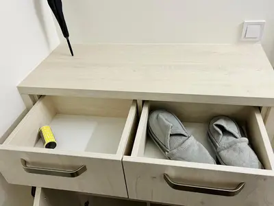 a drawer in a cabinet with shoes in it at Pleasant Basement Apartment in Prague