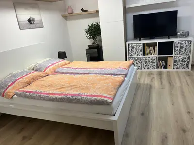 a bedroom with a bed and a flat screen tv at Relax pobyt na břehu Sázavy a na dosah Prahy in Čerčany