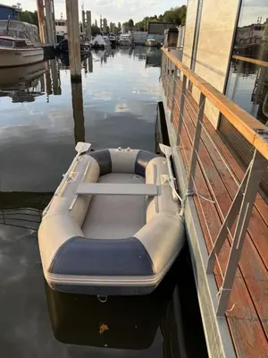 a boat sitting on the water next to a dock at Prague Stream in Prague