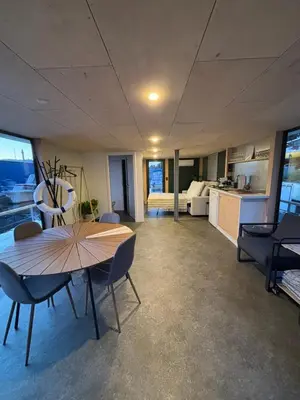 a room with a table and chairs and a kitchen at Prague Stream in Prague