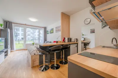 a kitchen with a counter and stools in a room at Garden Studio near Metro Kolbenova in Prague