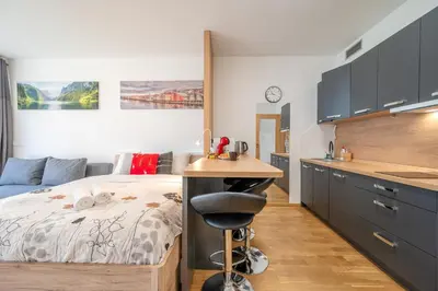 a bedroom with a bed and a desk in it at Garden Studio near Metro Kolbenova in Prague