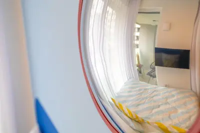 a mirror reflection of a bed in a bedroom at Colorful Apartment - Balcony, Free Parking, by Gravity Prague in Prague