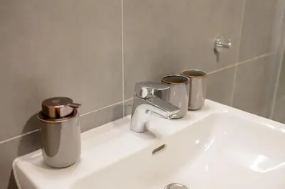 a bathroom sink with two trash cans on it at Colorful Apartment - Balcony, Free Parking, by Gravity Prague in Prague