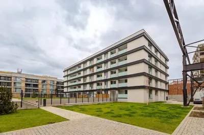 an apartment building with a lawn in front of it at Colorful Apartment - Balcony, Free Parking, by Gravity Prague in Prague