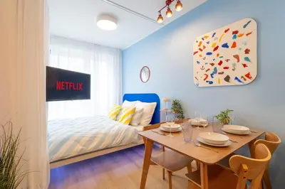 a dining room with a table and a bed at Colorful Apartment - Balcony, Free Parking, by Gravity Prague in Prague