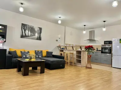 a living room with a couch and a table at Apartmán v srdci Poděbrad 100m2 in Poděbrady
