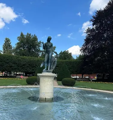 a statue of a woman sitting on top of a fountain at Apartmán v srdci Poděbrad 100m2 in Poděbrady