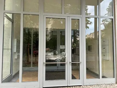 a group of glass doors with a car in it at Apartmán v srdci Poděbrad 100m2 in Poděbrady