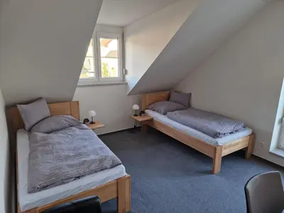 a bedroom with two beds in a attic at Ubytování Pod věží Hoštka u Roudnice nad Labem in Litoměřice