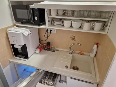 a small kitchen with a sink and a microwave at Ubytování Pod věží Hoštka u Roudnice nad Labem in Litoměřice