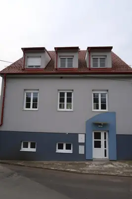 a large white house with a red roof at Ubytování Pod věží Hoštka u Roudnice nad Labem in Litoměřice