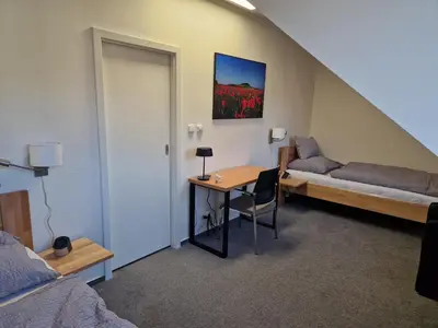 a room with a bed and a desk in a room at Ubytování Pod věží Hoštka u Roudnice nad Labem in Litoměřice