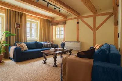a living room with blue couches and a table at NELIS I Boutique Apartments in Old Town in Prague