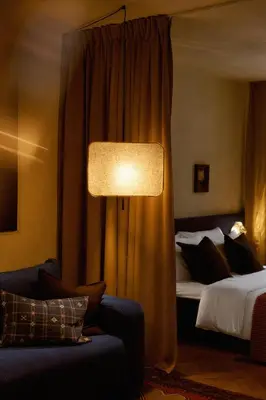 a room with two beds and a couch and a lamp at NELIS I Boutique Apartments in Old Town in Prague