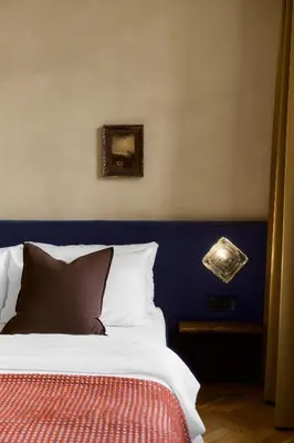 a bedroom with a bed with a blue head board at NELIS I Boutique Apartments in Old Town in Prague