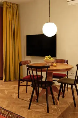 a dining room with a table and chairs and a television at NELIS I Boutique Apartments in Old Town in Prague