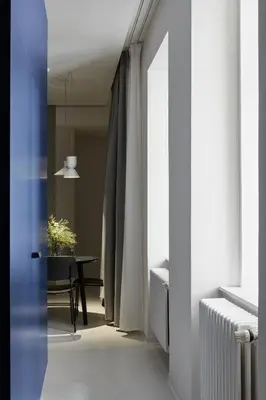 a hallway with a room with a table and a window at Grace Apartment by Prague Castle in Prague