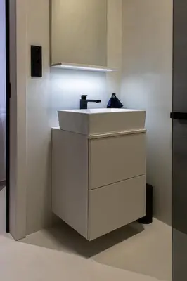 a bathroom with a white sink and a mirror at Grace Apartment by Prague Castle in Prague