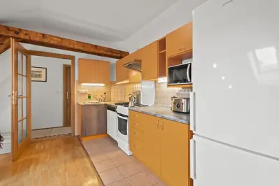 a kitchen with yellow cabinets and a microwave at Vintage APTs in Heart of Prague by Michal&Friends in Prague