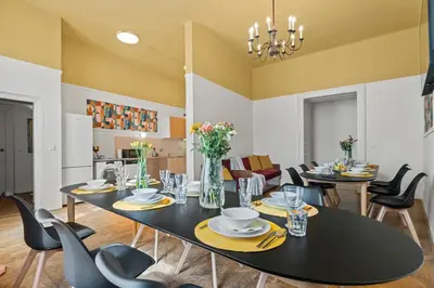 a dining room with a black table and chairs at Vintage APTs in Heart of Prague by Michal&Friends in Prague
