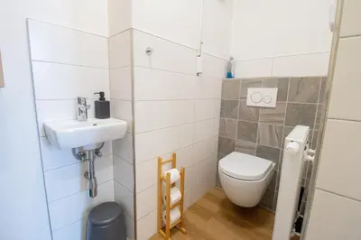 a small bathroom with a toilet and a sink at Stay Inn Apartments Ve smeckah in Prague