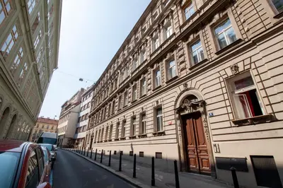 a building with a red door on the side of a street at Stay Inn Apartments Ve smeckah in Prague