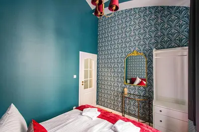 a bedroom with a bed and a mirror at 4BDR Old Town flat by Church of St Anne in Prague