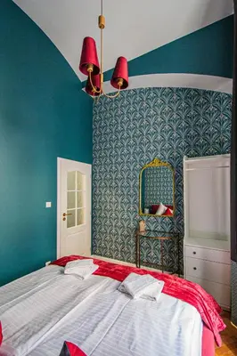 a bedroom with a large bed and a blue wall at 4BDR Old Town flat by Church of St Anne in Prague