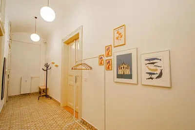 a hallway with a white wall with pictures on it at 3BDR main square spacious designed apartment in Prague