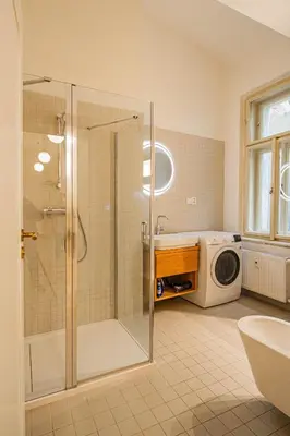 a bathroom with a shower and a microwave at 3BDR main square spacious designed apartment in Prague