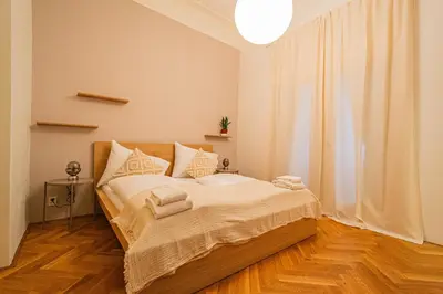 a bedroom with a bed with towels on it at 3BDR main square spacious designed apartment in Prague