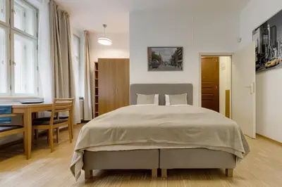 a bedroom with a large bed and a table at Deluxe suite in prime location in Prague