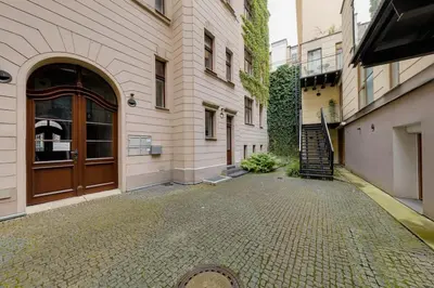 a building with a door and a brick street at Deluxe suite in prime location in Prague