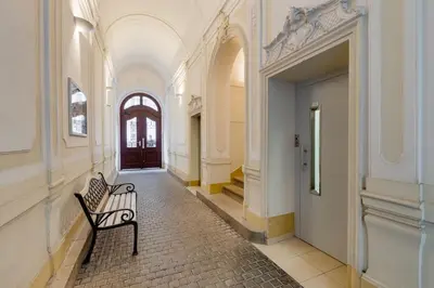 a empty hallway with a bench in a building at Deluxe suite in prime location in Prague