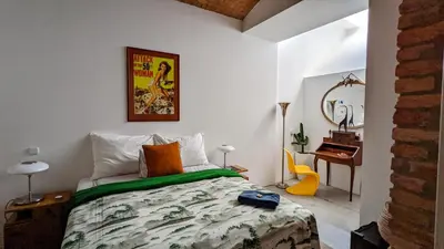 a bedroom with a bed and a desk in a room at Romantic and atypical apartments in Prague's Montmartre in Prague