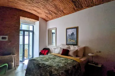 a bedroom with a bed and a brick wall at Romantic and atypical apartments in Prague's Montmartre in Prague
