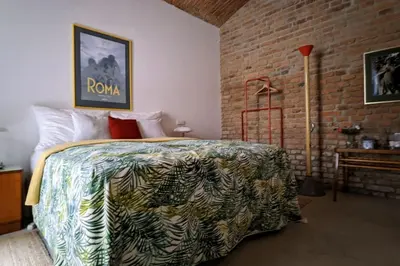 a bedroom with a bed and a brick wall at Romantic and atypical apartments in Prague's Montmartre in Prague