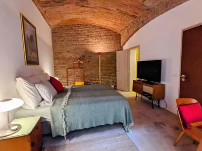 a bedroom with a bed and a tv in a room at Romantic and atypical apartments in Prague's Montmartre in Prague