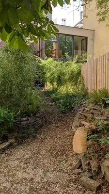 a house with a stone path in front of a building at Romantic and atypical apartments in Prague's Montmartre in Prague