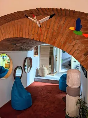 a room with a ceiling with a bird and mirrors at Romantic and atypical apartments in Prague's Montmartre in Prague