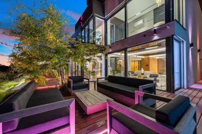 a house with purple benches on a patio at Chandelier Sky Mansion in Tuchoměřice