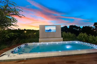 a swimming pool with a tv on top of it at Chandelier Sky Mansion in Tuchoměřice