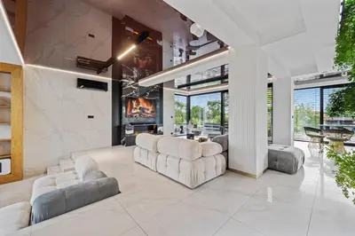 a living room with couches and a fireplace at Chandelier Sky Mansion in Tuchoměřice