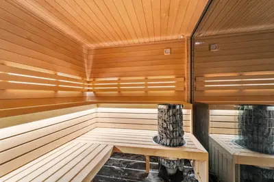 a wooden sauna with a bench and a vase in it at Chandelier Sky Mansion in Tuchoměřice